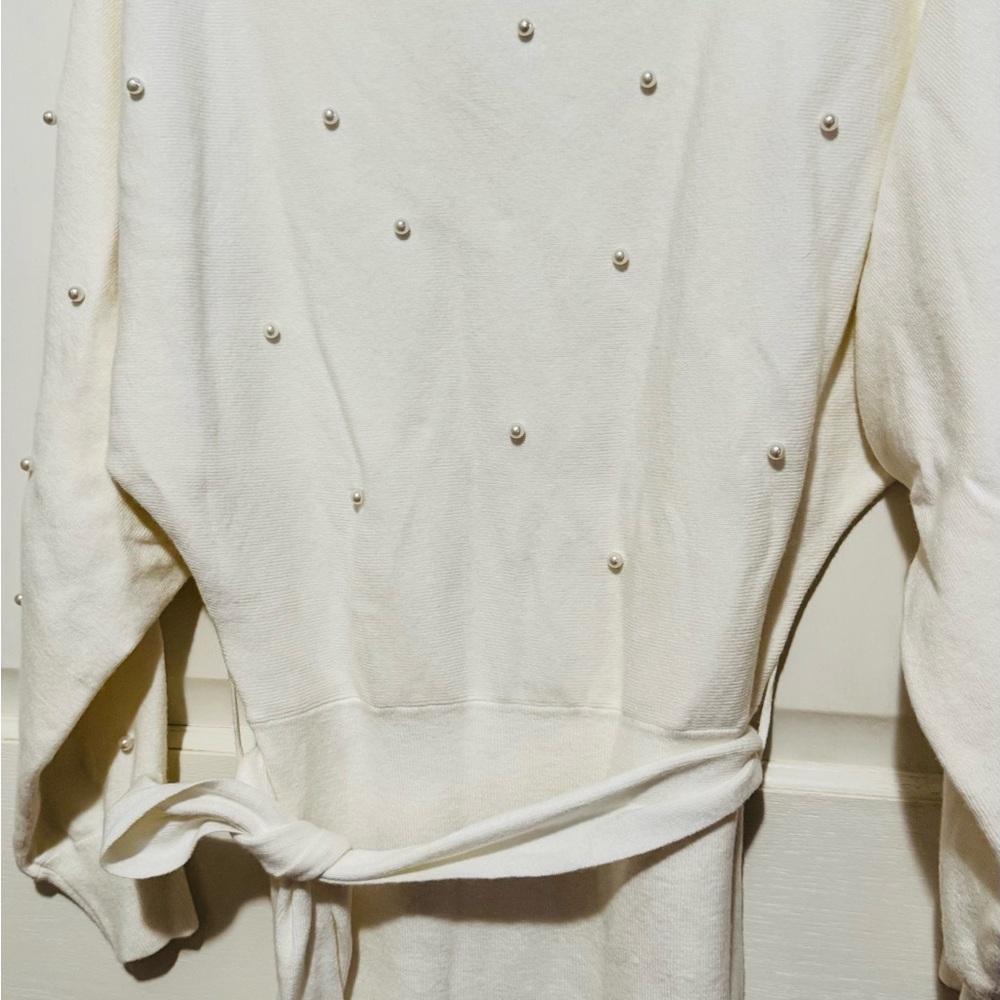 Beautiful cream-colored long-sleeved dress with pearls